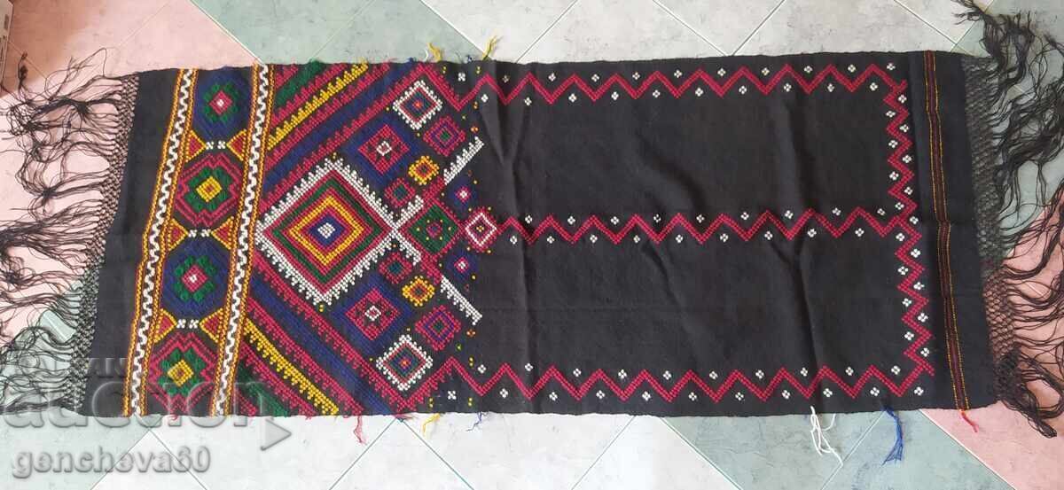 Fucked, hand-woven colorful rug for a divan, under the roof