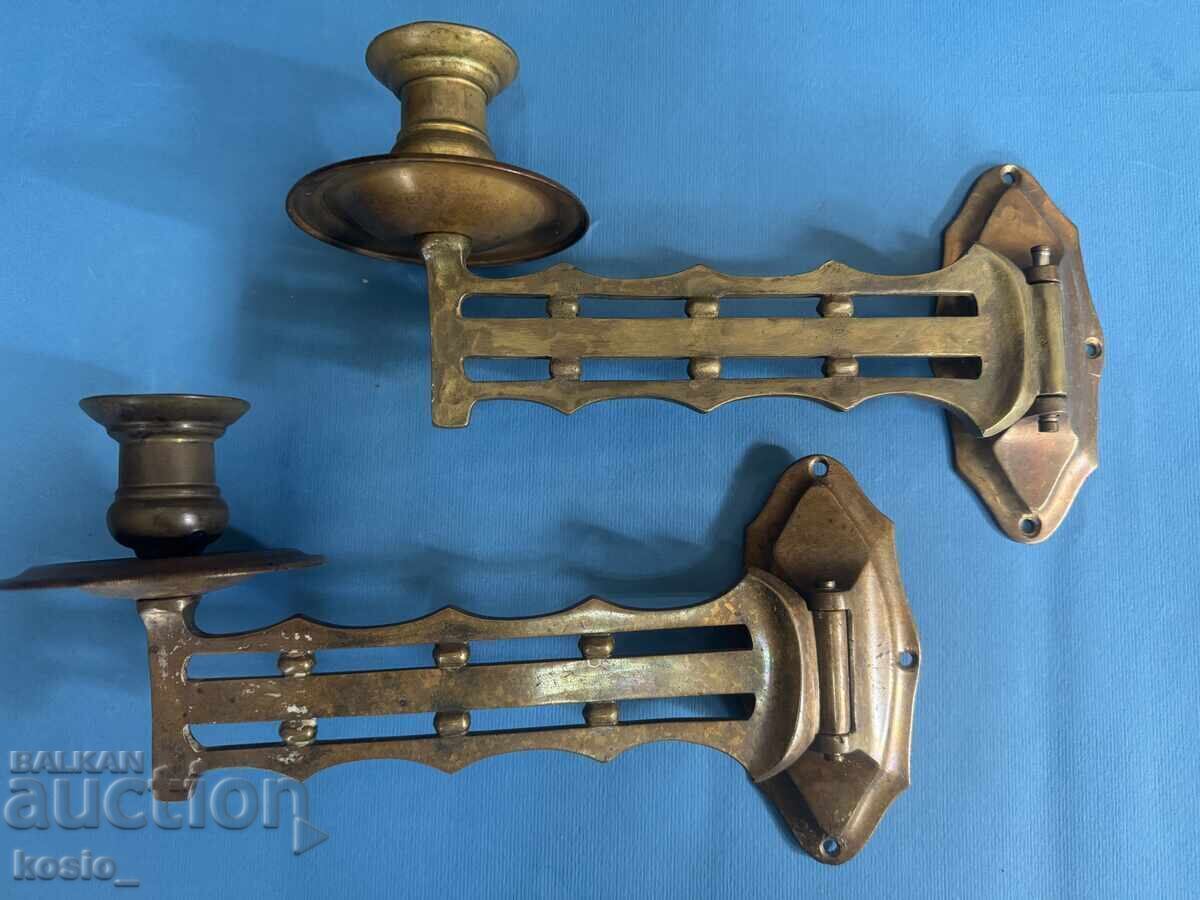 Auction  Set of brass piano candlesticks