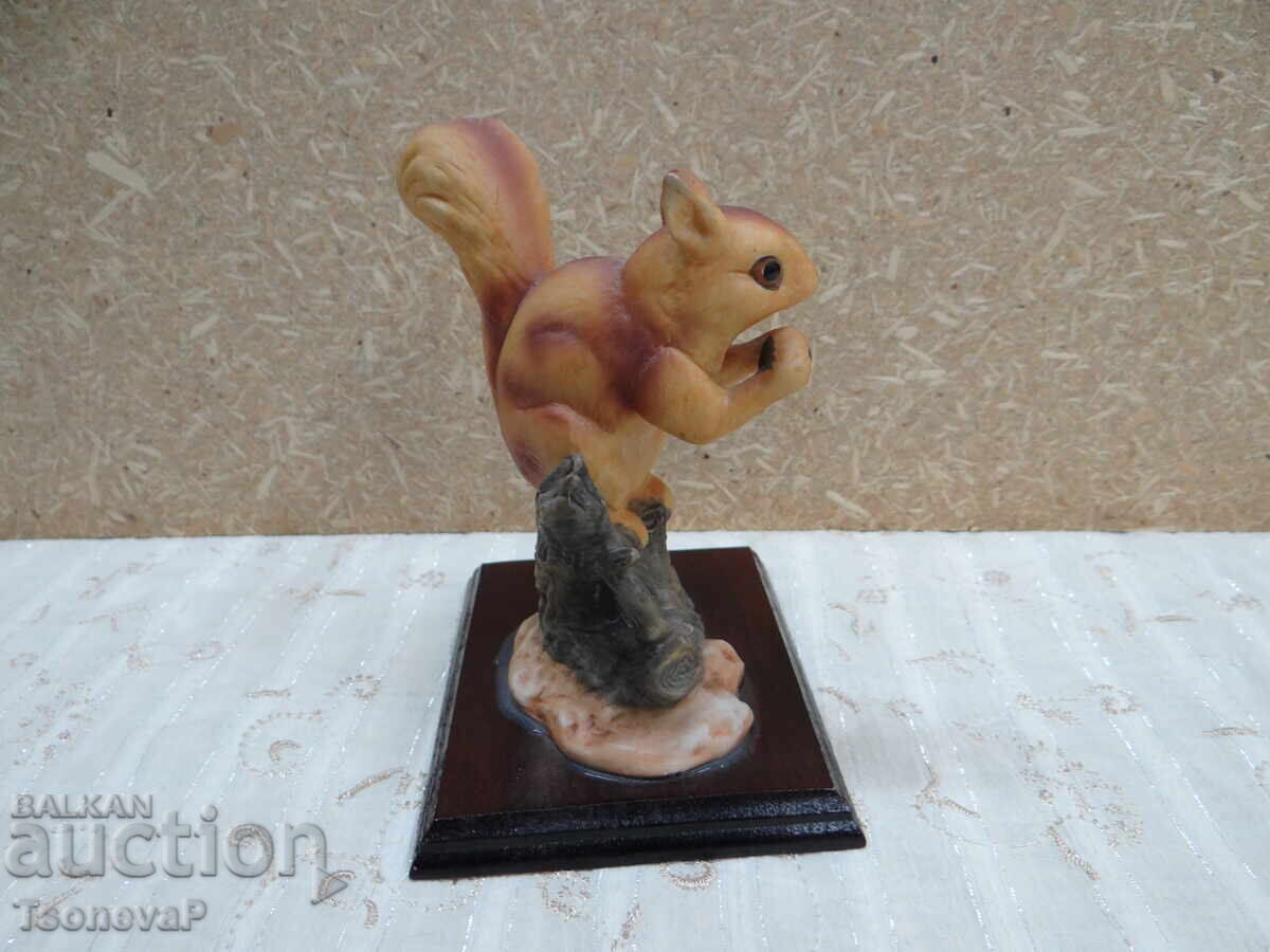 Figurine of a red squirrel on a wooden base with price 18.00 BGN | € 9.20 Figurine of a red squirrel on a wooden base with price 18.00 BGN | € 9.20