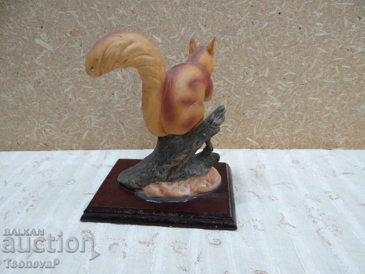 Auction Figurine of a red squirrel on a wooden base Auction Figurine of a red squirrel on a wooden base