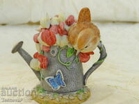 Bird figurine, watering can, flowers, butterfly