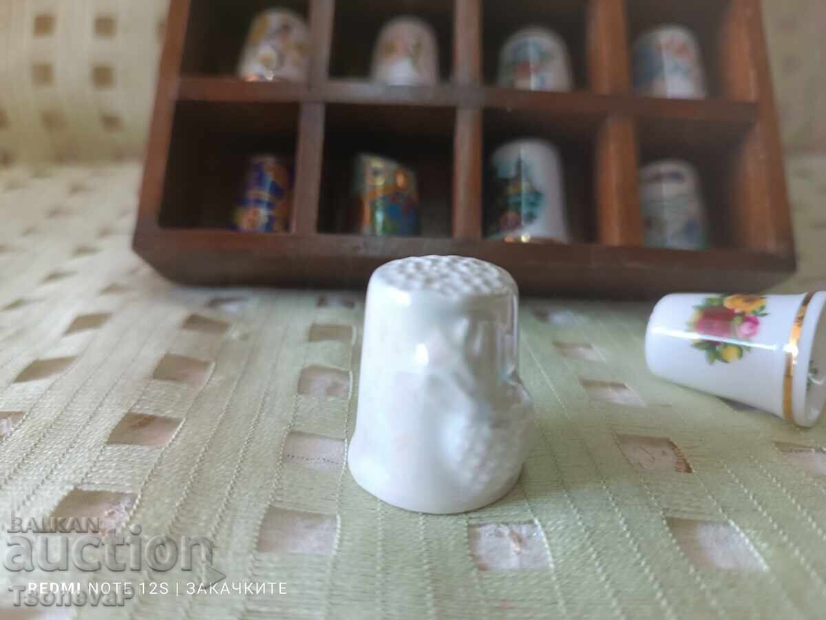 Delivery of Collection of thimbles with a wooden shelf Delivery of Collection of thimbles with a wooden shelf