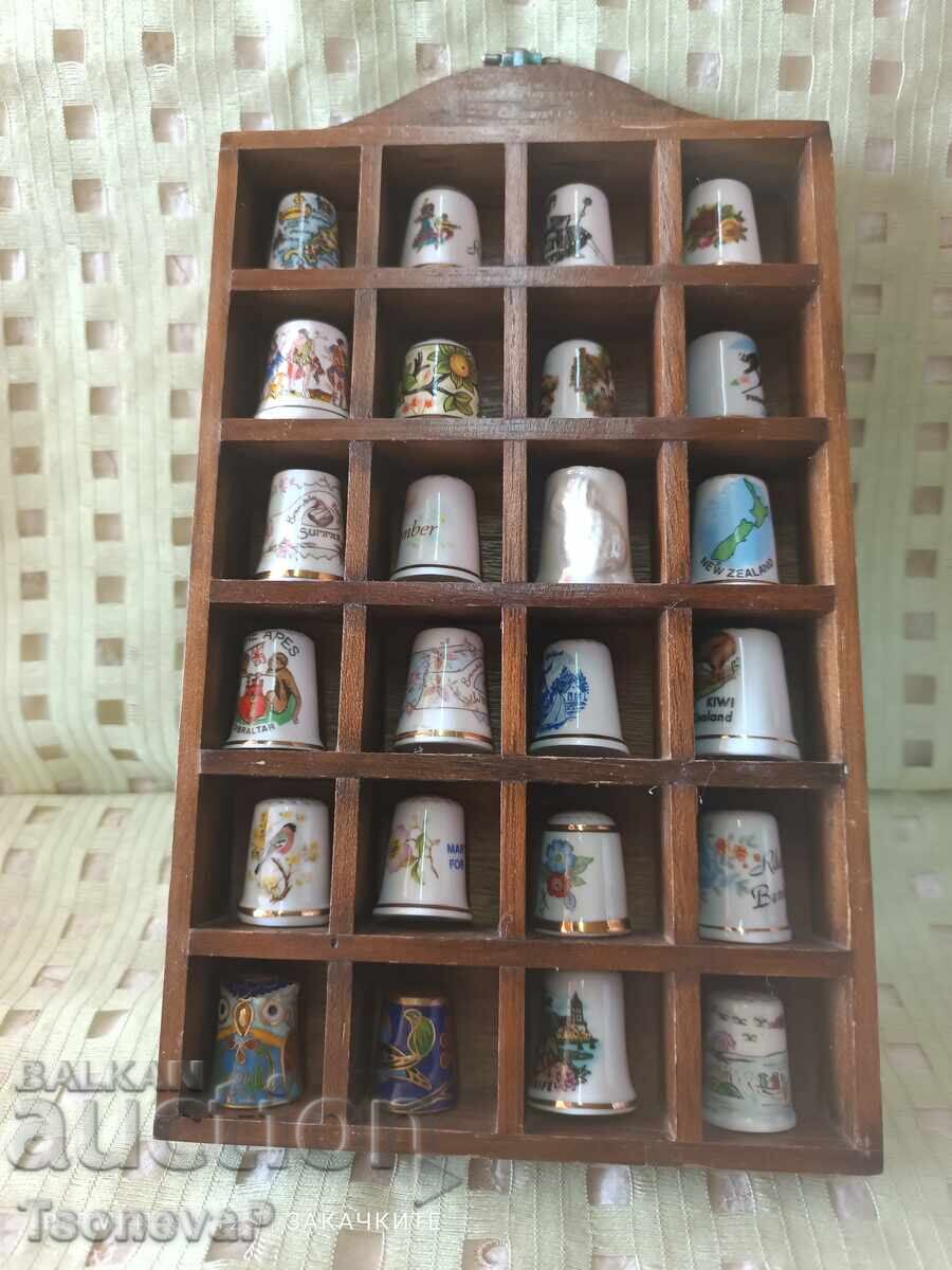 Collection of thimbles with a wooden shelf Collection of thimbles with a wooden shelf