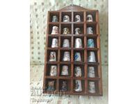 Collection of thimbles with a wooden shelf