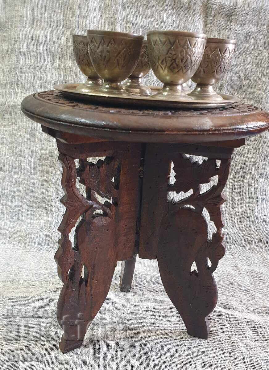 Old Arabic wooden table and set of hand-forged cups