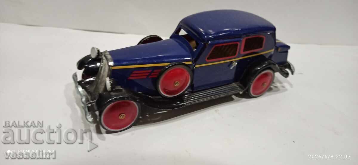 Old sheet metal car with a wind-up friction mechanism