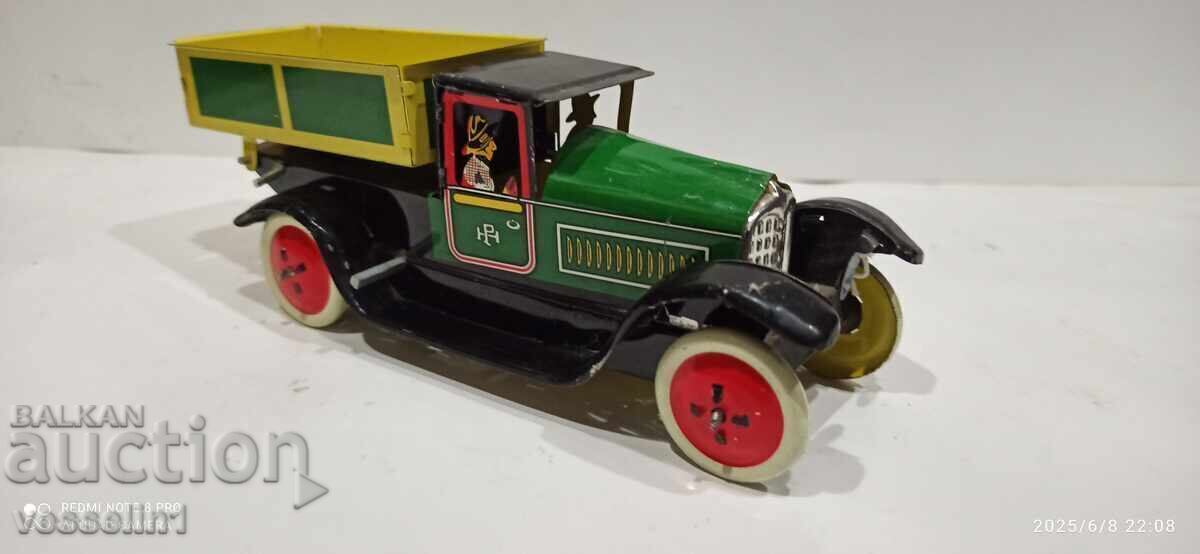 Old sheet metal truck with a wind-up friction mechanism