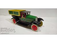 Old sheet metal truck with a wind-up friction mechanism