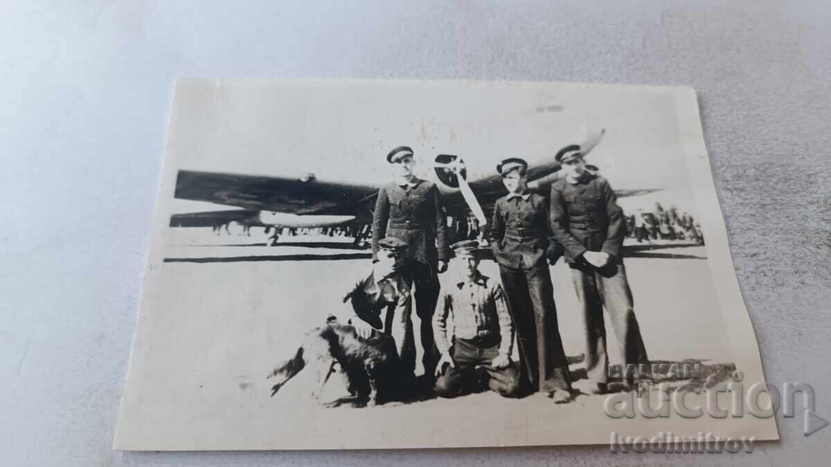 Photo of Five Pilots in Front of a Propeller Plane on the Runway Photo of Five Pilots in Front of a Propeller Plane on the Runway