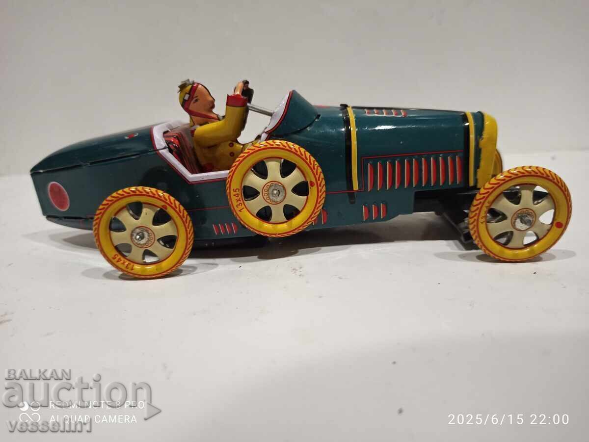 Old sheet metal car with a wind-up friction mechanism