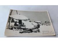 Fotografie Bărbat fumând țigară și întins pe plajă