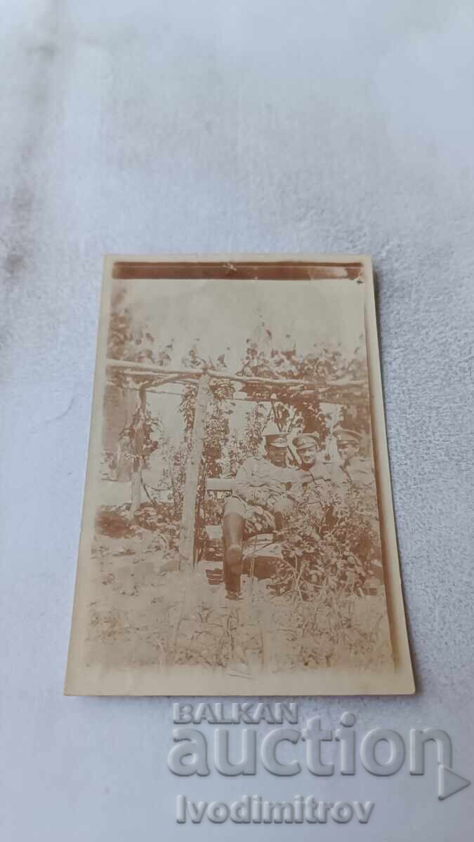 Photograph of Two Officers on a Bench Under a Vine Photograph of Two Officers on a Bench Under a Vine