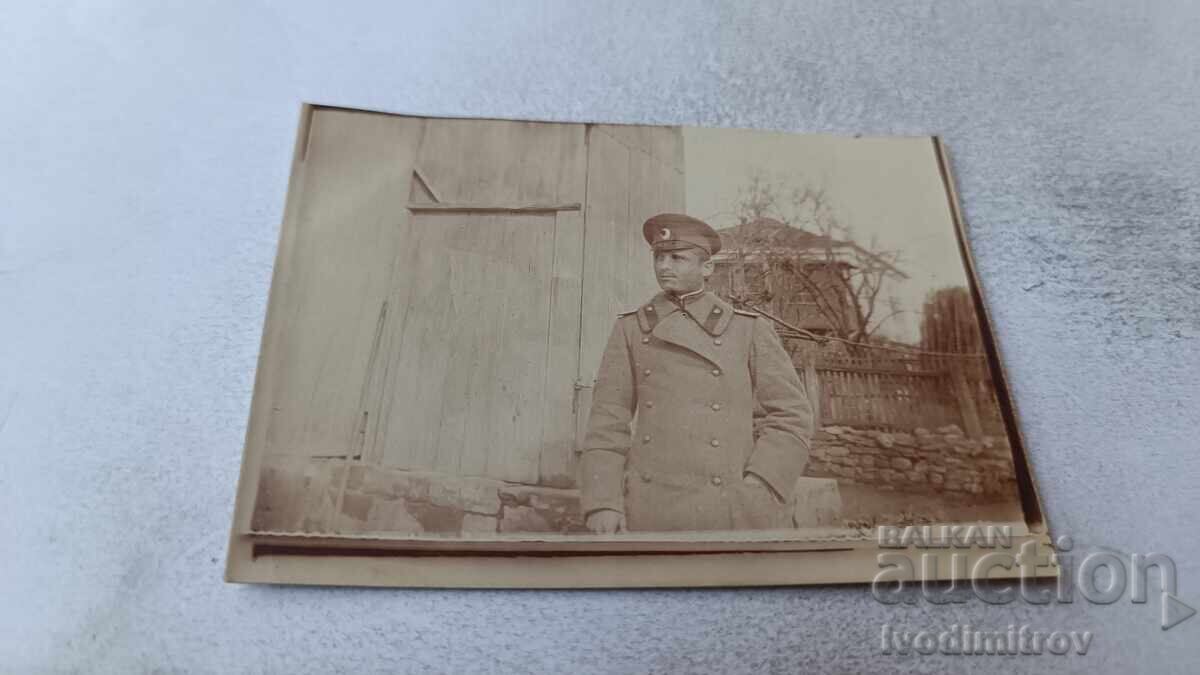 Photo of an Officer in the yard of a village house