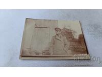 Photo of an Officer in the yard of a village house