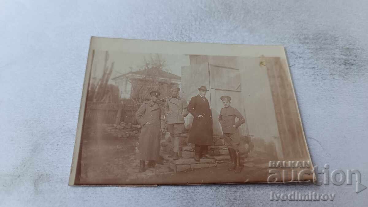 Photo of an Officer in the yard of a village house