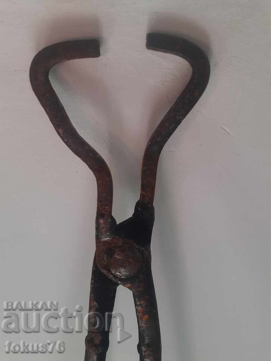 Old forged blacksmith tongs with long handles Old forged blacksmith tongs with long handles