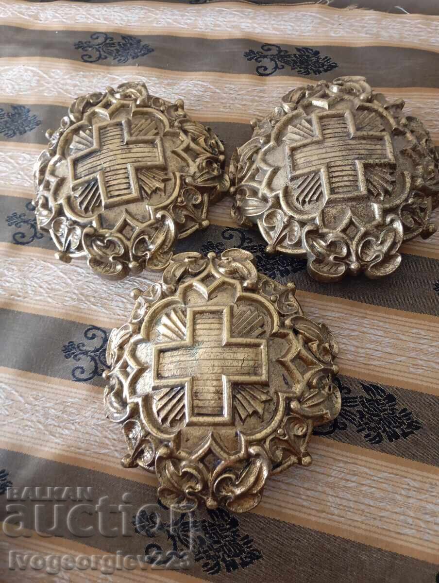 Three bronze appliqués, fittings