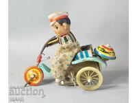 Old Chinese mechanical metal toy boy with tricycle