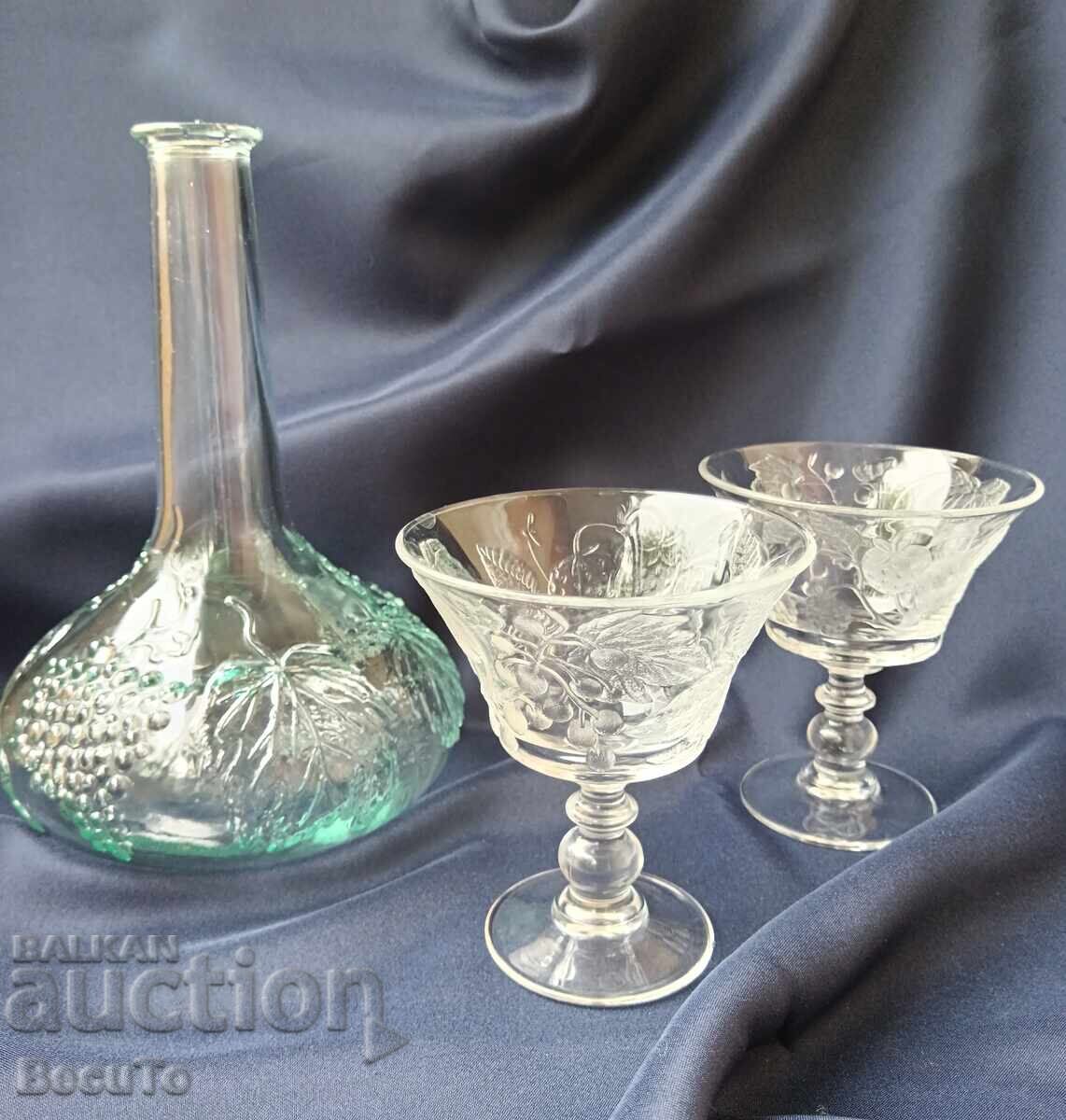 Pressed glass carafe and glasses on a stand with embossed fruit Pressed glass carafe and glasses on a stand with embossed fruit