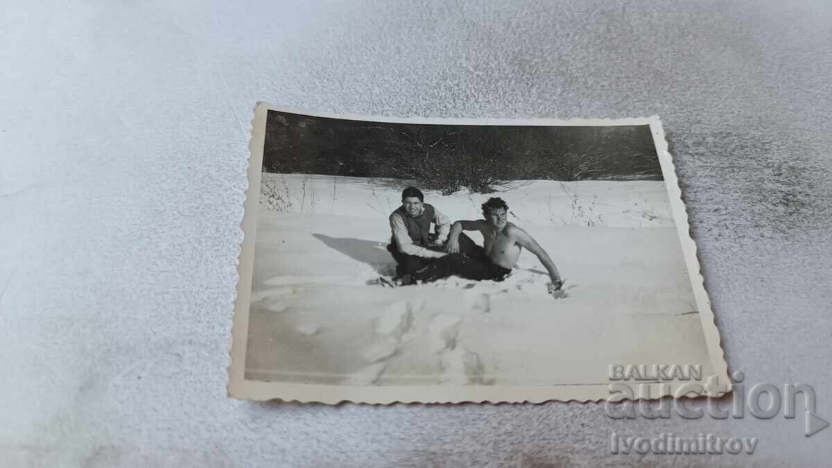 Photo of Two Young Men, Bare-Chested, in the Snow