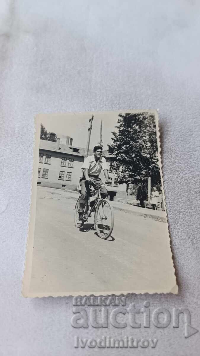 Photo of a Man with a Retro Bicycle on the Street 1957