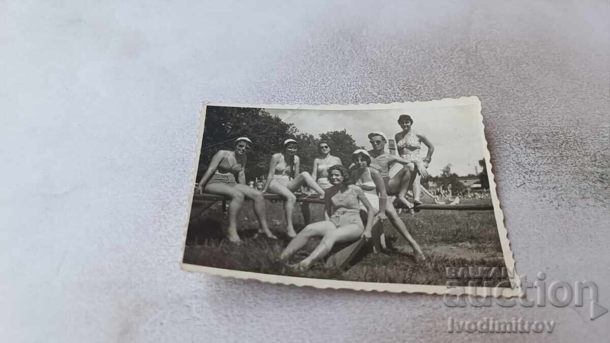 Photo of a Man and Young Girls in Retro Swimsuits