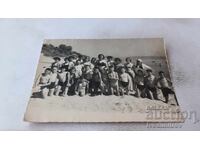 Photo of Students with their Teacher on the Beach