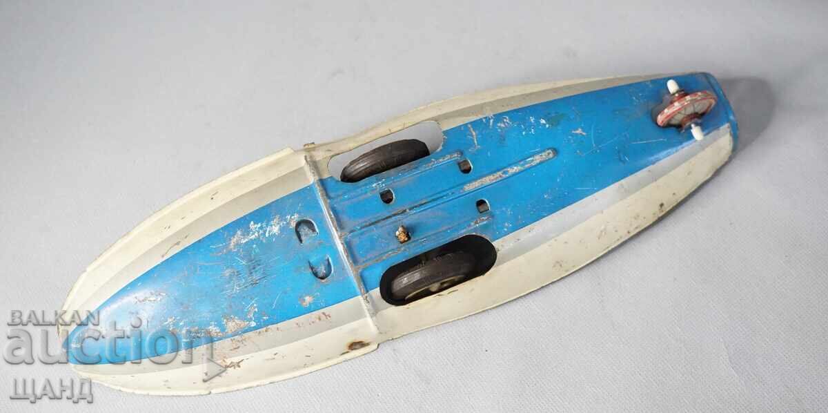 Motherboard with tires. Old metal toy model boat ship