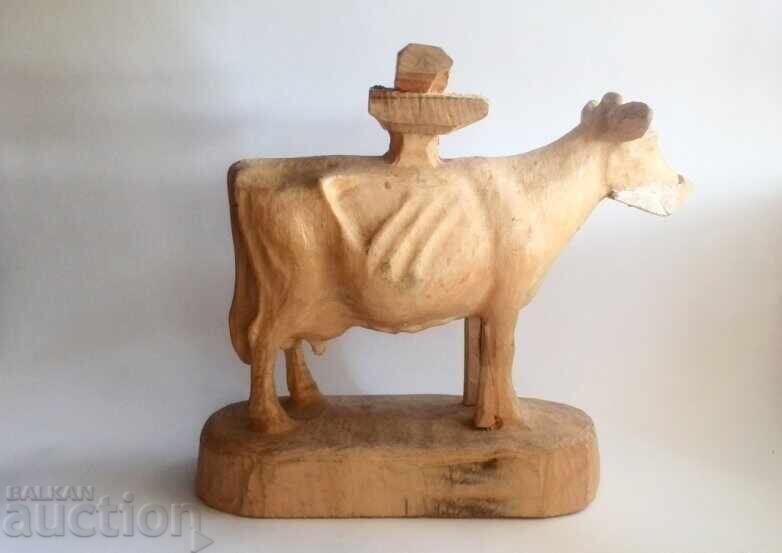 Unfinished large wood carving of a cow figure