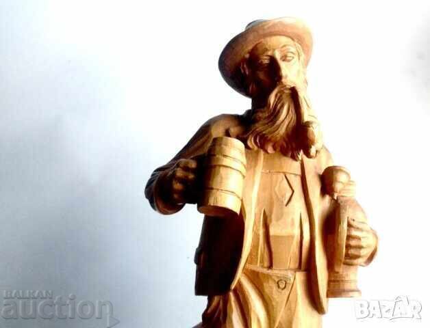 Delivery of Old large wooden figure of a hunter with a pipe and a beer mug