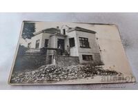 Photo of a man, woman, and little girl in front of a single-family house