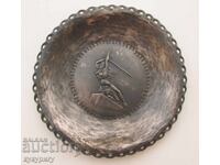 Old handmade metal wall plate with a mermaid