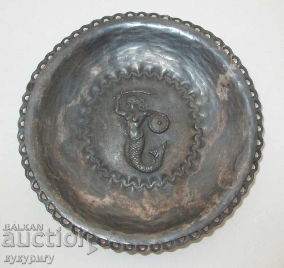 Old handmade metal wall plate with a mermaid Old handmade metal wall plate with a mermaid