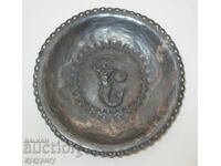 Old handmade metal wall plate with a mermaid