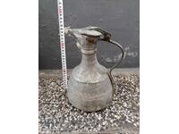 Old copper jug with inscriptions