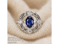 Designer ring with natural sapphire and white topazes