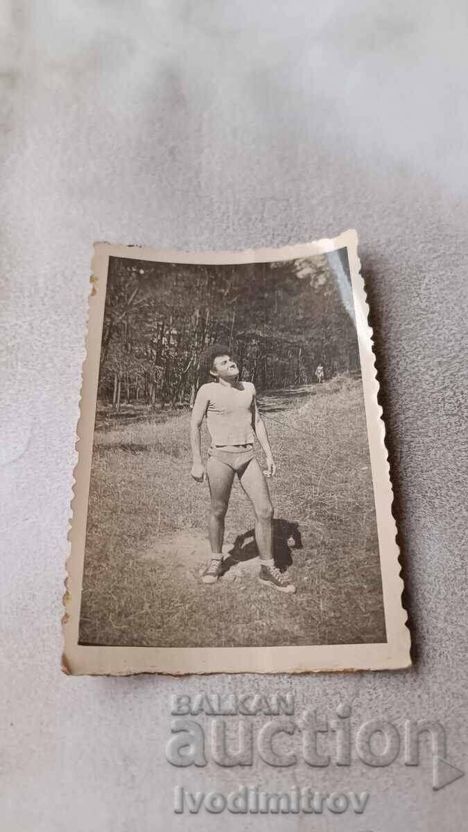 Photo of a Man in Shorts on the Meadow