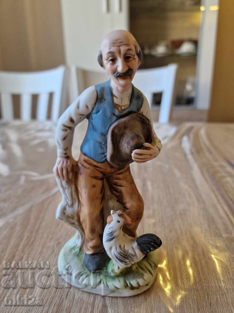 Bătrân cu o figurină de găină Bătrân cu o figurină de găină