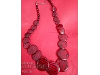 Antique necklace of red mother-of-pearl and black lines