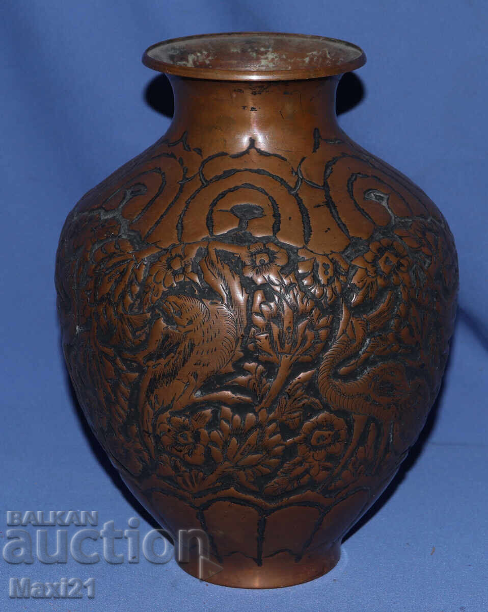 Old copper vase with floral motifs