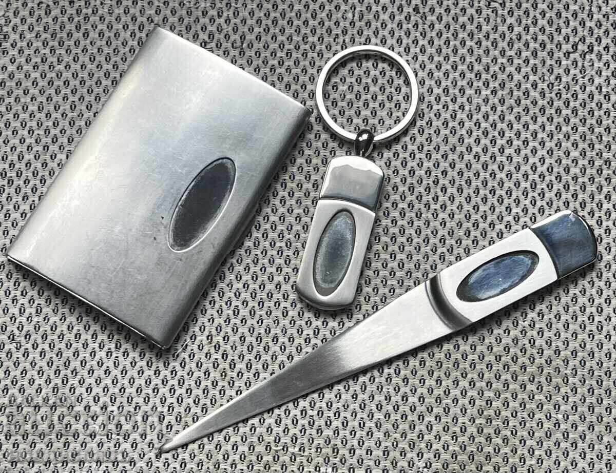 Set of metal letter opener, business card holder, and keychain