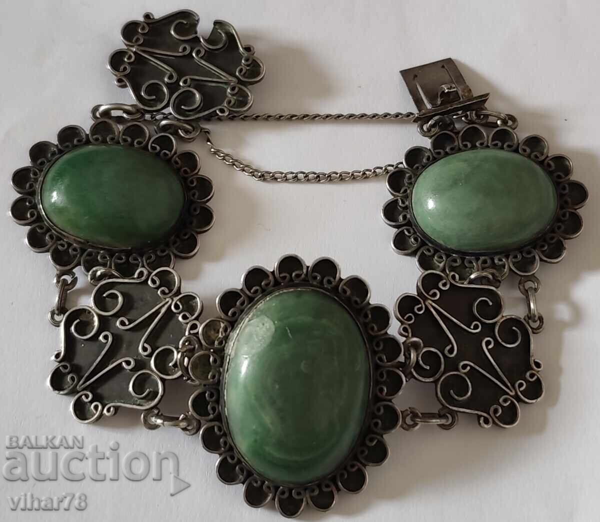 Silver bracelet with three large green stones