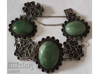 Silver bracelet with three large green stones