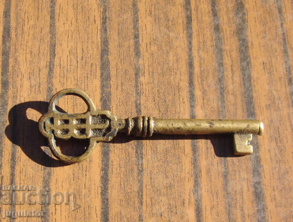 Old antique bronze key, bronze key from a safe JB