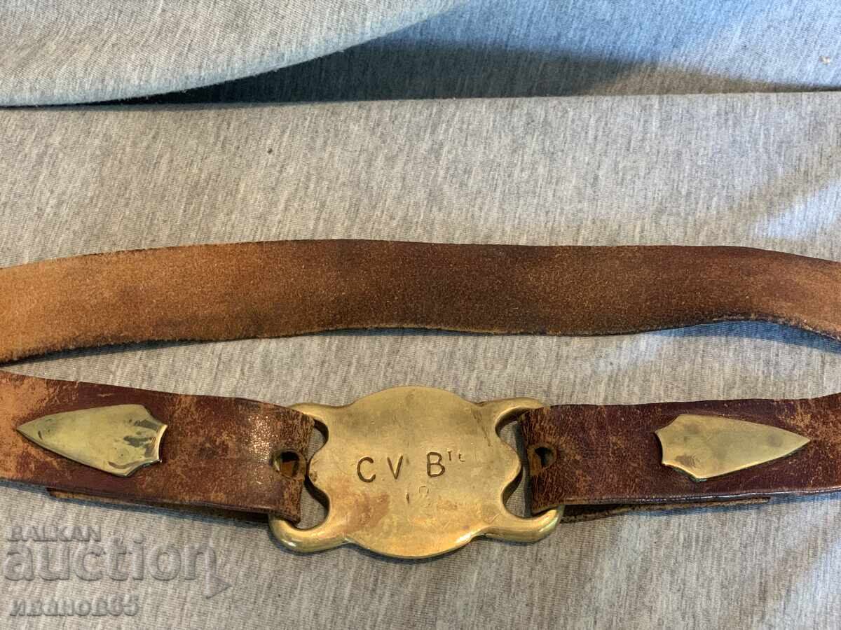 Old leather belt with brass buckle and decorations