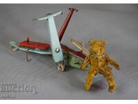 Old mechanical metal toy scooter model with bear