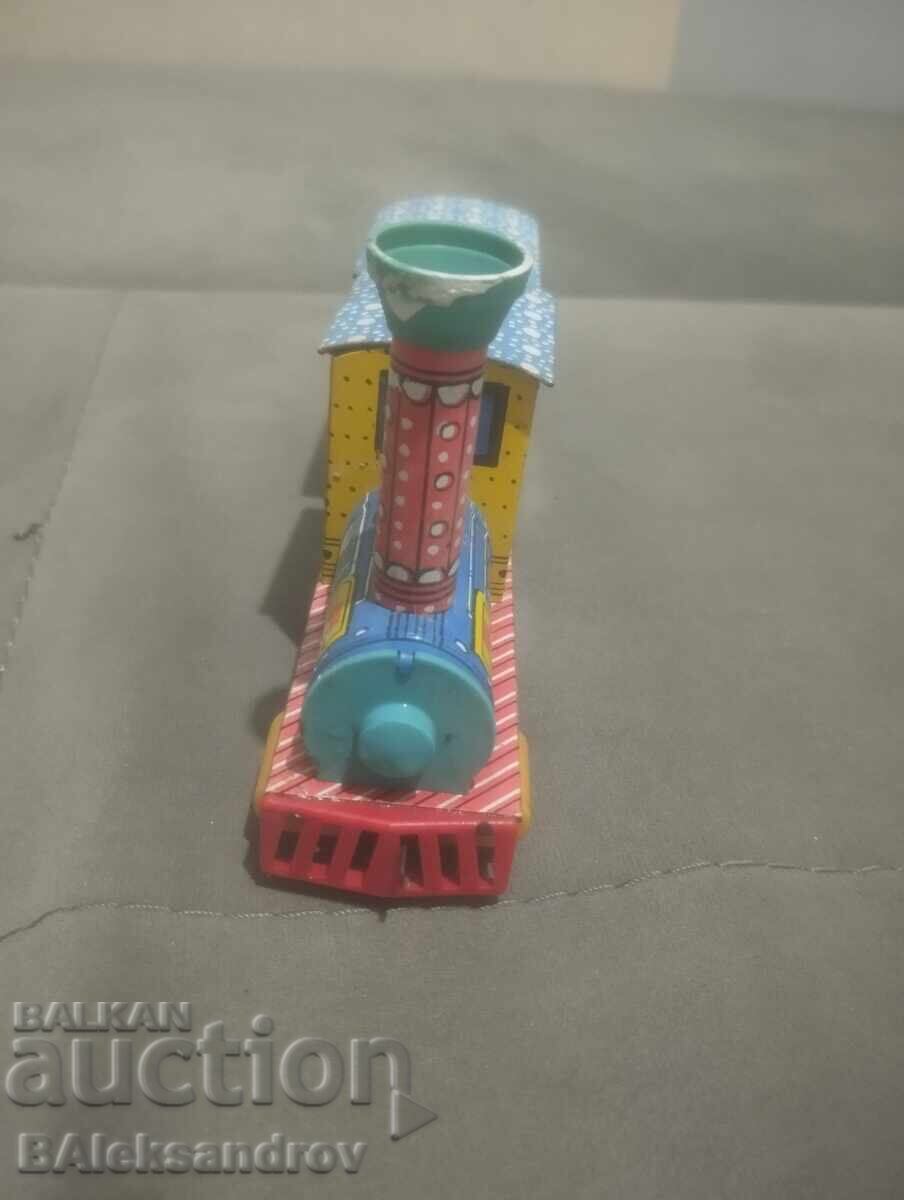 Livrarea Jucărie veche mecanică din tablă