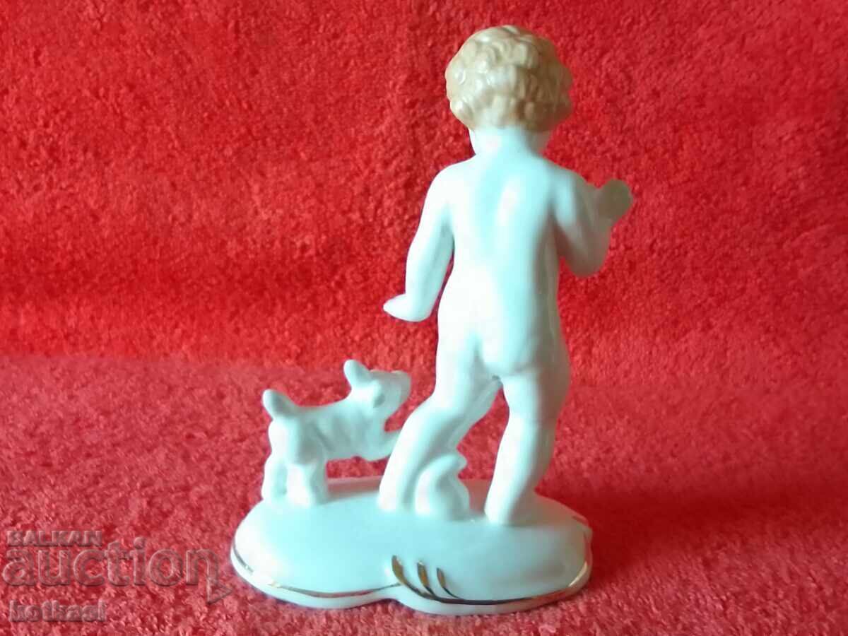 Delivery of Old porcelain figure of a child, boy playing with a dog