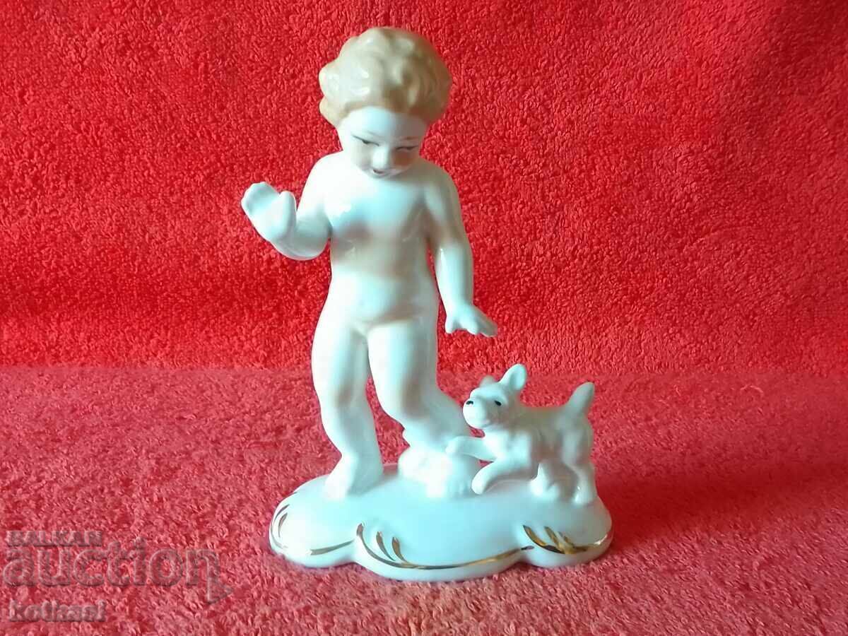 Old porcelain figure of a child, boy playing with a dog