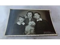 Photo: Woman, two young girls, and a poodle dog